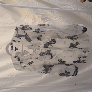 Ann Taylor white blouse with navy print and ruffle detail.